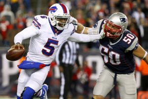 Nov 23, 2015; Foxborough, MA, USA; Buffalo Bills quarterback Tyrod Taylor (5) tries to break free from New England Patriots defensive end Rob Ninkovich (50) during the second half at Gillette Stadium. Mandatory Credit: Winslow Townson-USA TODAY Sports