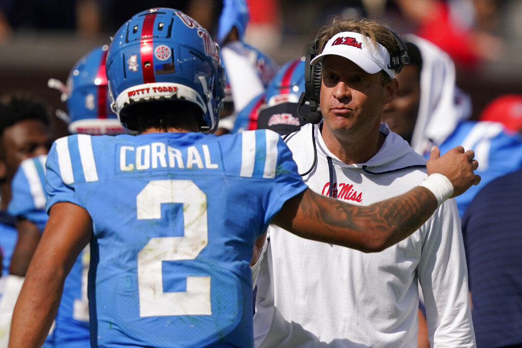 Matt Corral of the Mississippi Rebels looks to pass against the  Ole  miss football, College football uniforms, Ole miss rebels football