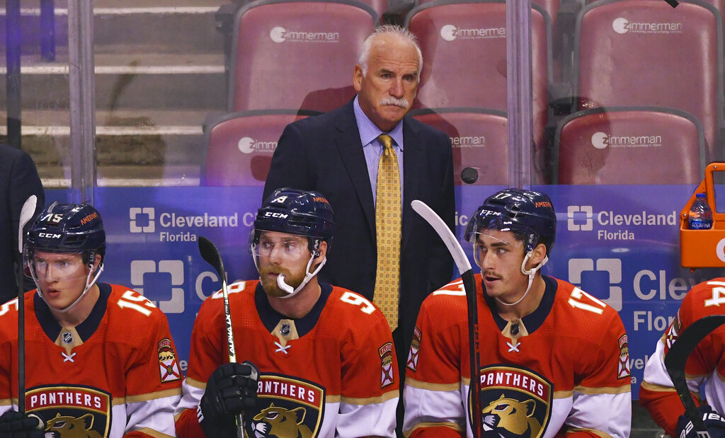 Colorado Avalanche head coach Joel Quenneville (R) wears his old