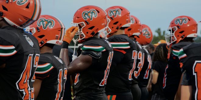 Eastside High School Football players lined up on sideline