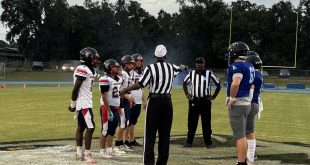 St. Francis Catholic and DeWitt Taylor meet at midfield for the pregame coinflip. [Charlie Jones]