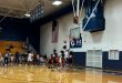 Santa Fe’s freshman point guard, Sylvester Lewis, shooting a layup over NFP defenders. [Liz Landen]