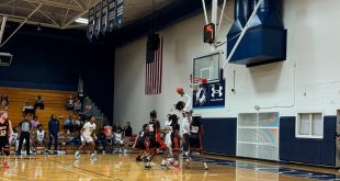 Santa Fe’s freshman point guard, Sylvester Lewis, shooting a layup over NFP defenders. [Liz Landen]