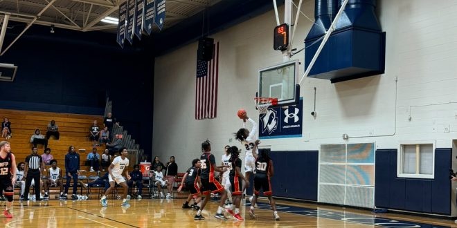 Santa Fe’s freshman point guard, Sylvester Lewis, shooting a layup over NFP defenders. [Liz Landen]